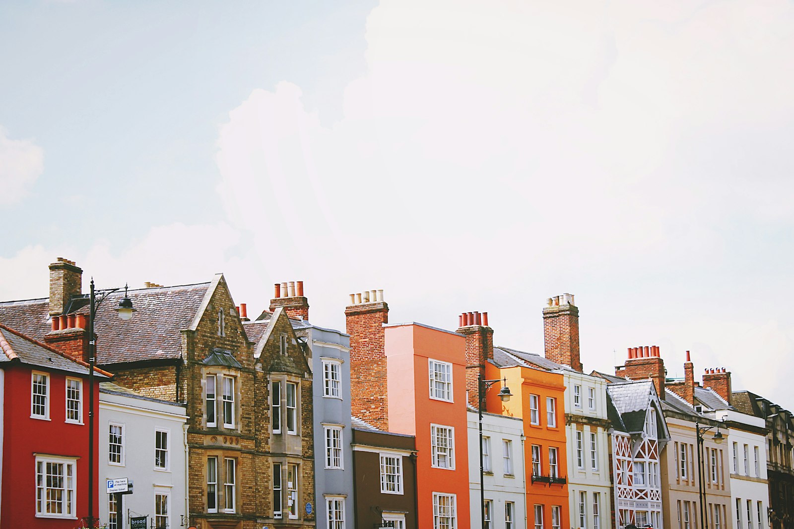 Row of characterful European townhouses in warm terracotta and cream